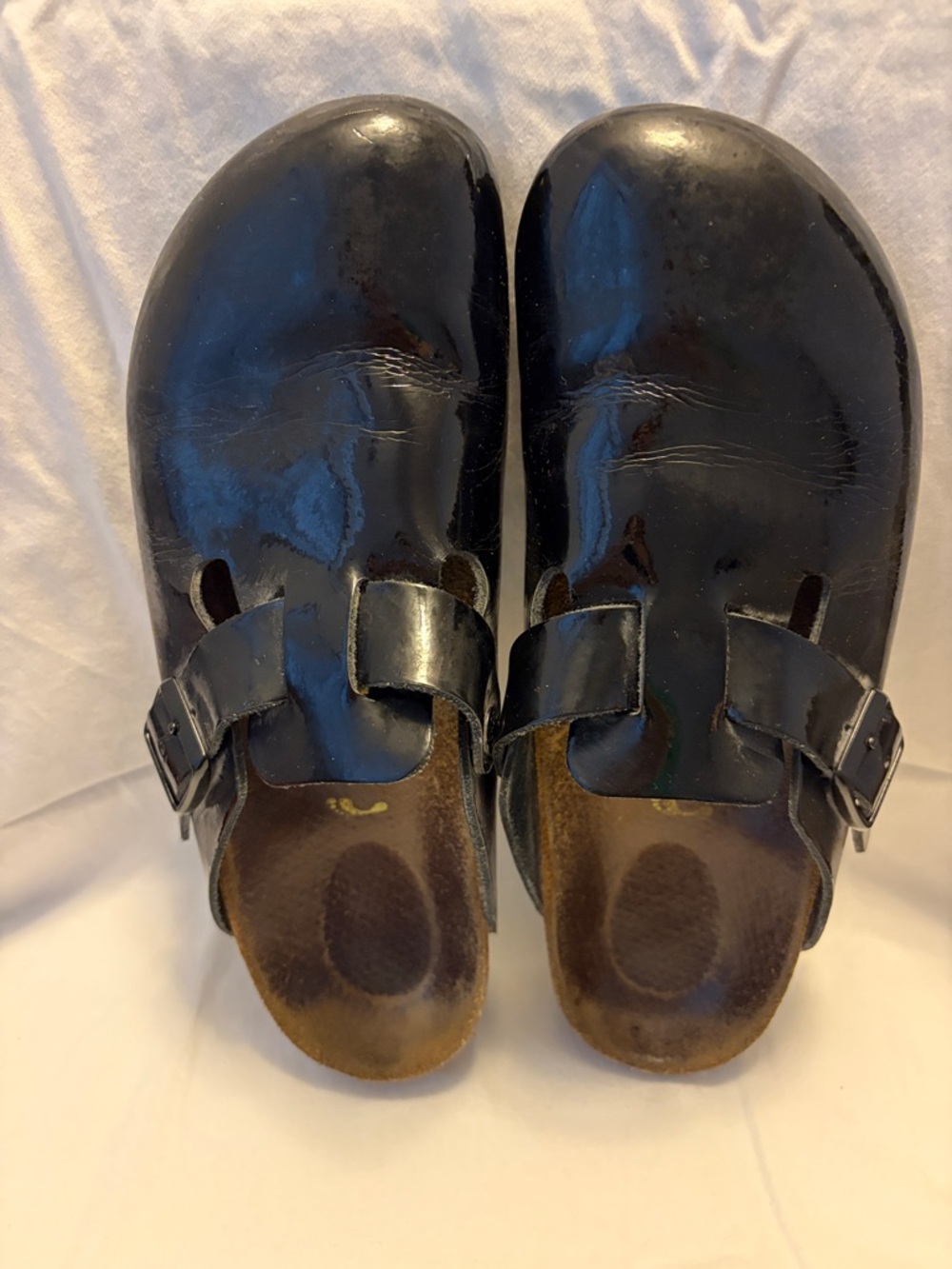 Birkenstock black patent leather clogs.